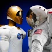 photo of a robot looking at an astronaut