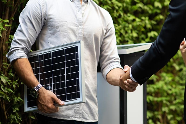 solar salesman showing a panel to a home owner