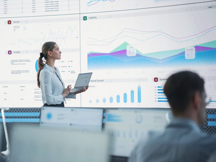 director reviewing growth metrics on a screen