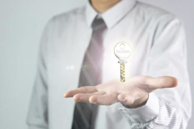photo of a sales rep holding the key to success