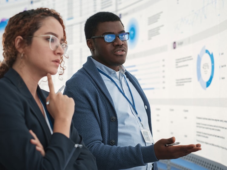 sales managers looking at a digital screen with data