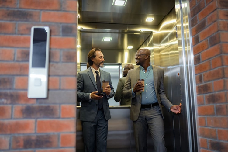 photo of two businessman on an elevator